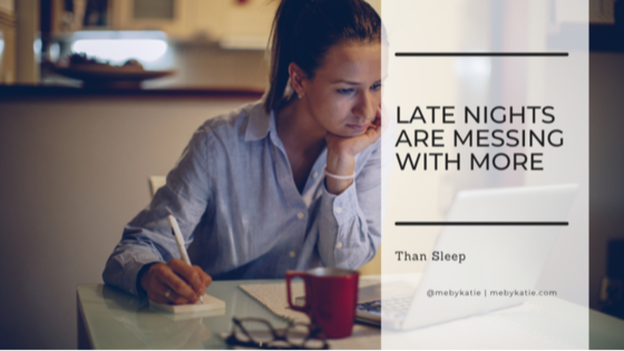 Woman working on her laptop late at night in a dim room @mebykatie