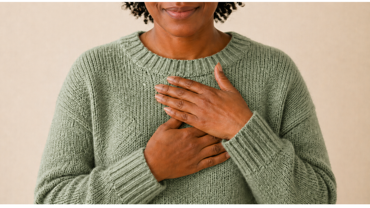 Woman holding her chest symbolizing healing the mother wound and reconnecting with self
