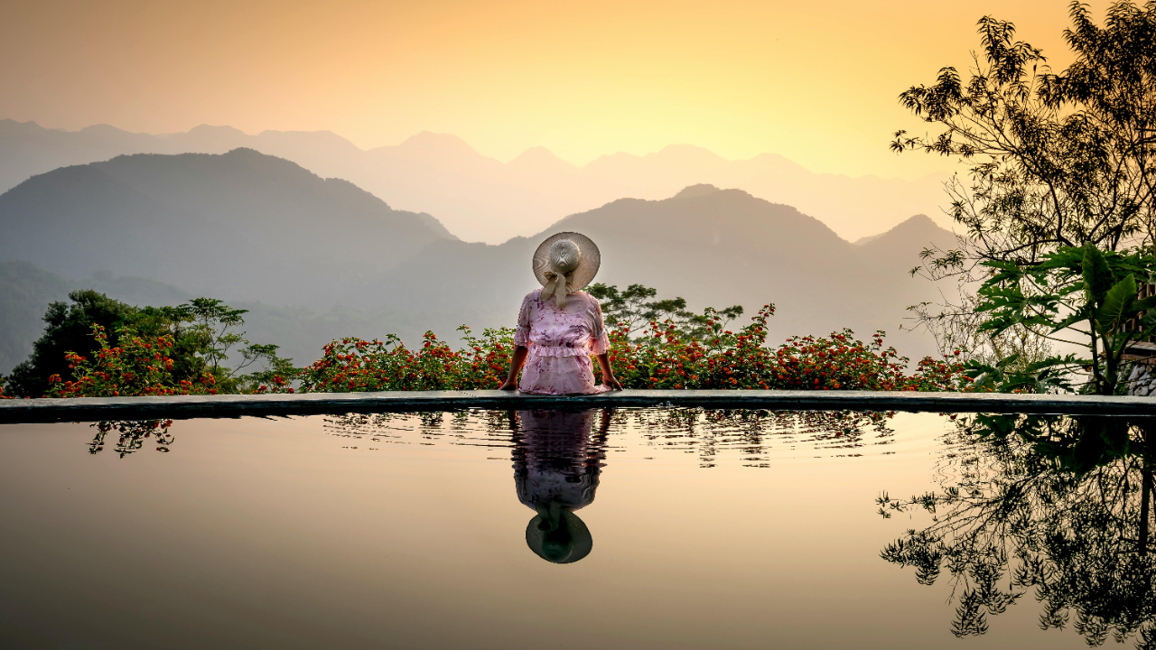 Woman sitting alone reflecting on fulfillment and emotional healing at sunset