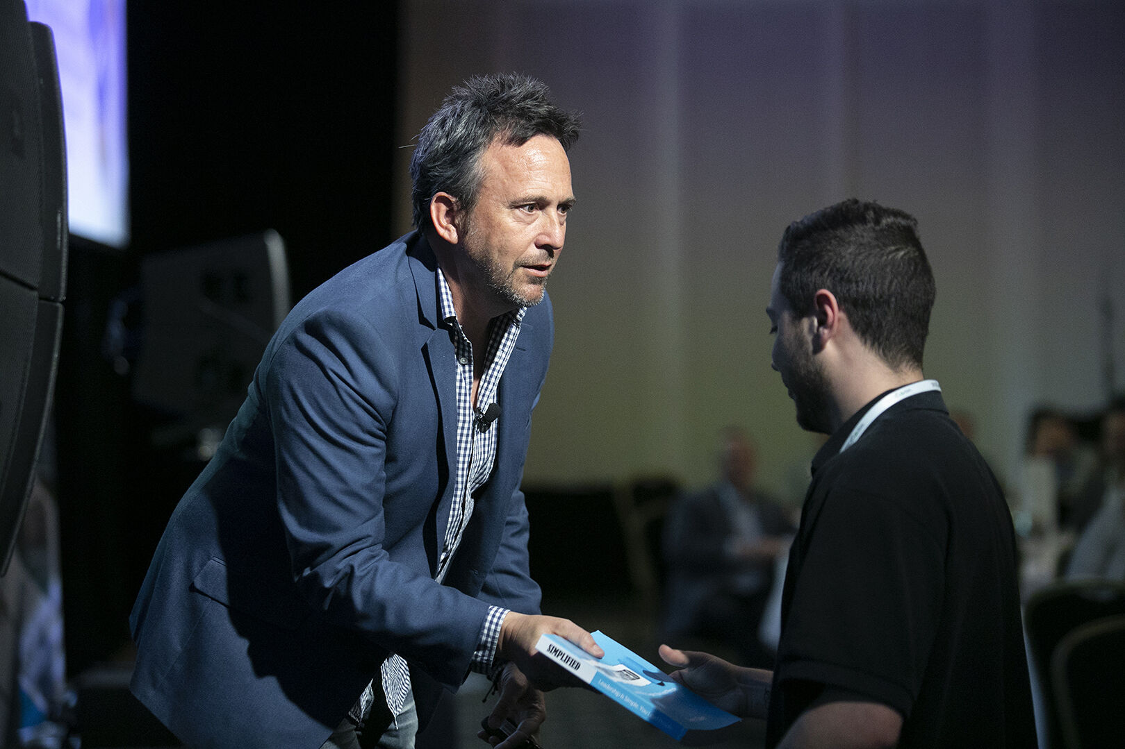 Dave Clare sharing his book SIMPLIFIED with a delegate after speaking