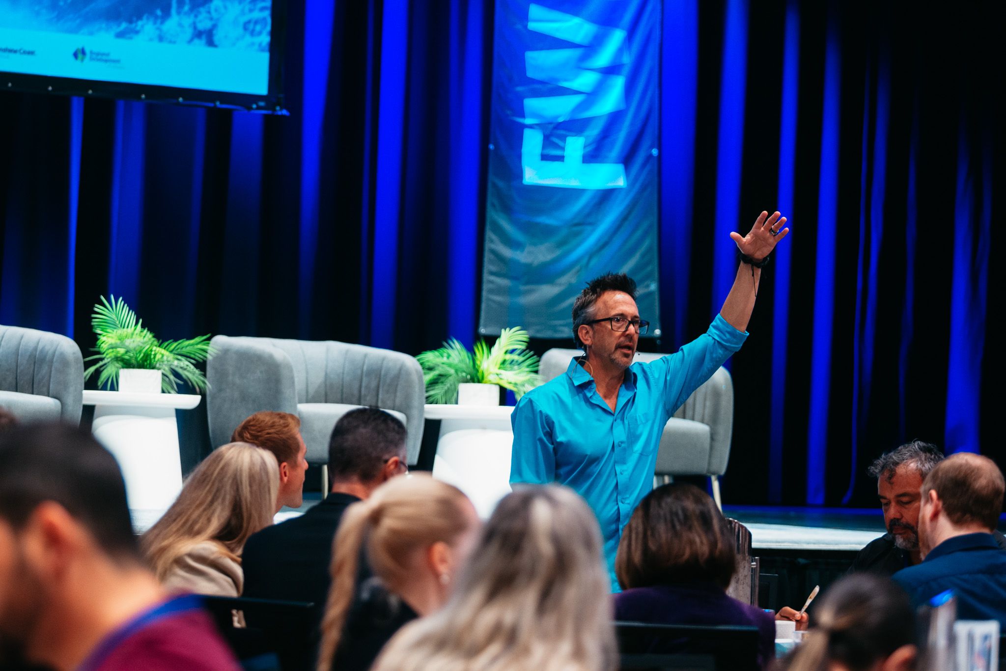Dave Clare engaging delegates at FWD Fest, hand raised