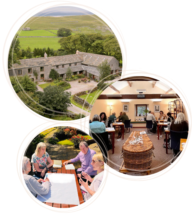 A scenic landscape at High Trenhouse showcases a stone building embraced by lush greenery. Outdoors, groups gather, discussing Celebrant Training amidst nature's beauty, while indoors others engage in conversation around tables in this serene residential setting.