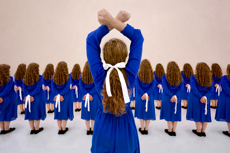 A trick photograph of a woman's face glowing with colourful glow in the dark neon paint under UV black light. Learn how to do black light photography with this tutorial.