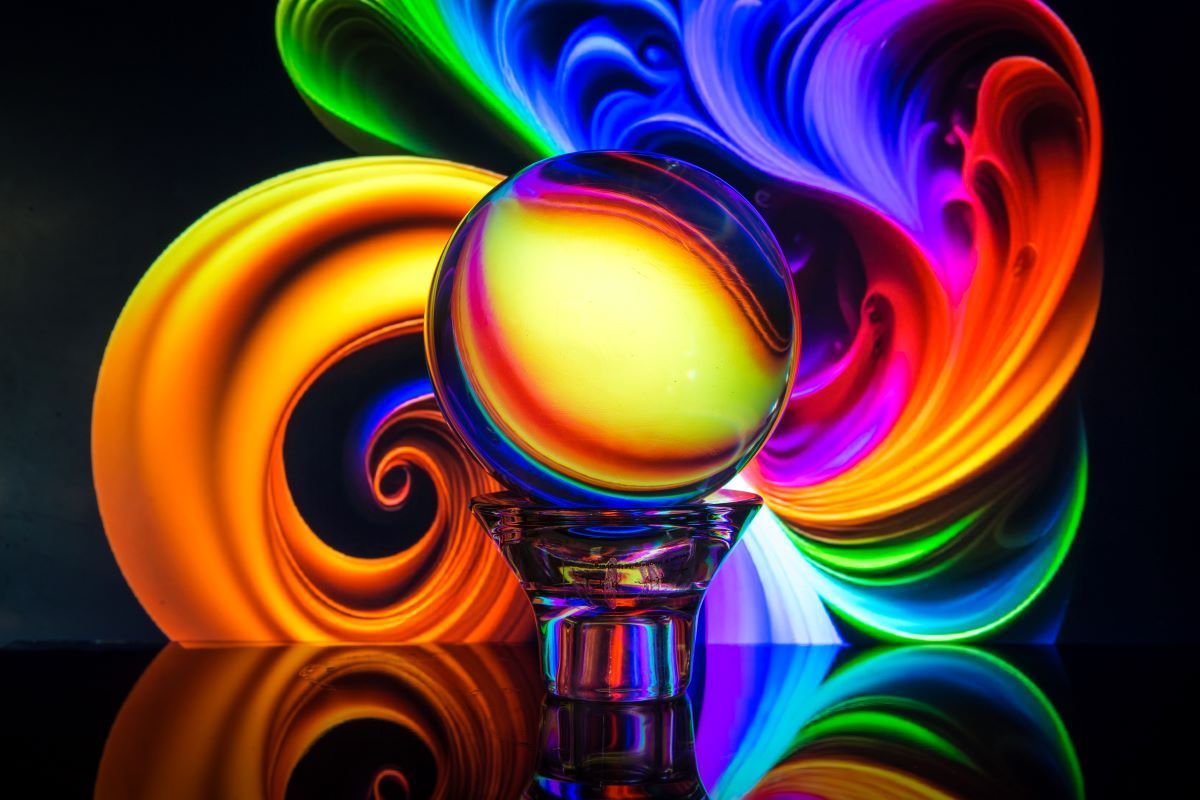 A photograph of a sky full of fireworks exploding over the city of Brisbane, reflected in the river, showing how to take fireworks photography long exposures.