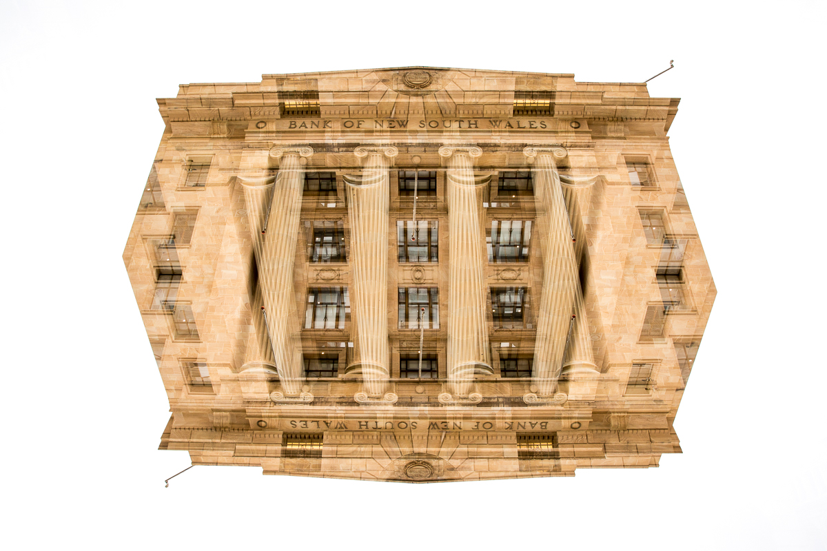 A high speed photograph capturing milk and coffee beans splashing into an owl mug for a tutorial on how to create photography tricks using flash lighting.