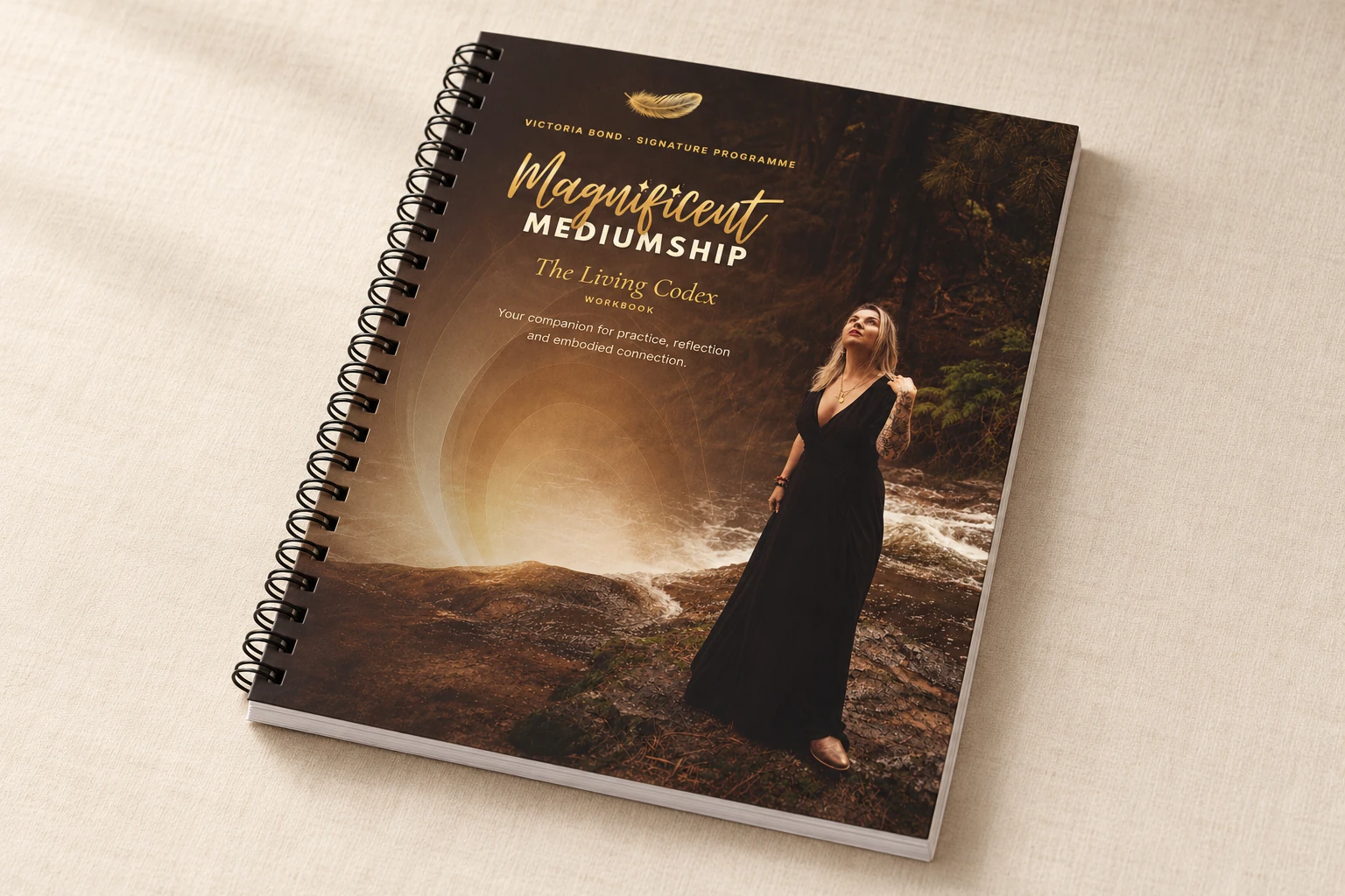 Your Magnificent Mediumship journal and workbook, wire bound, on an ivory surface