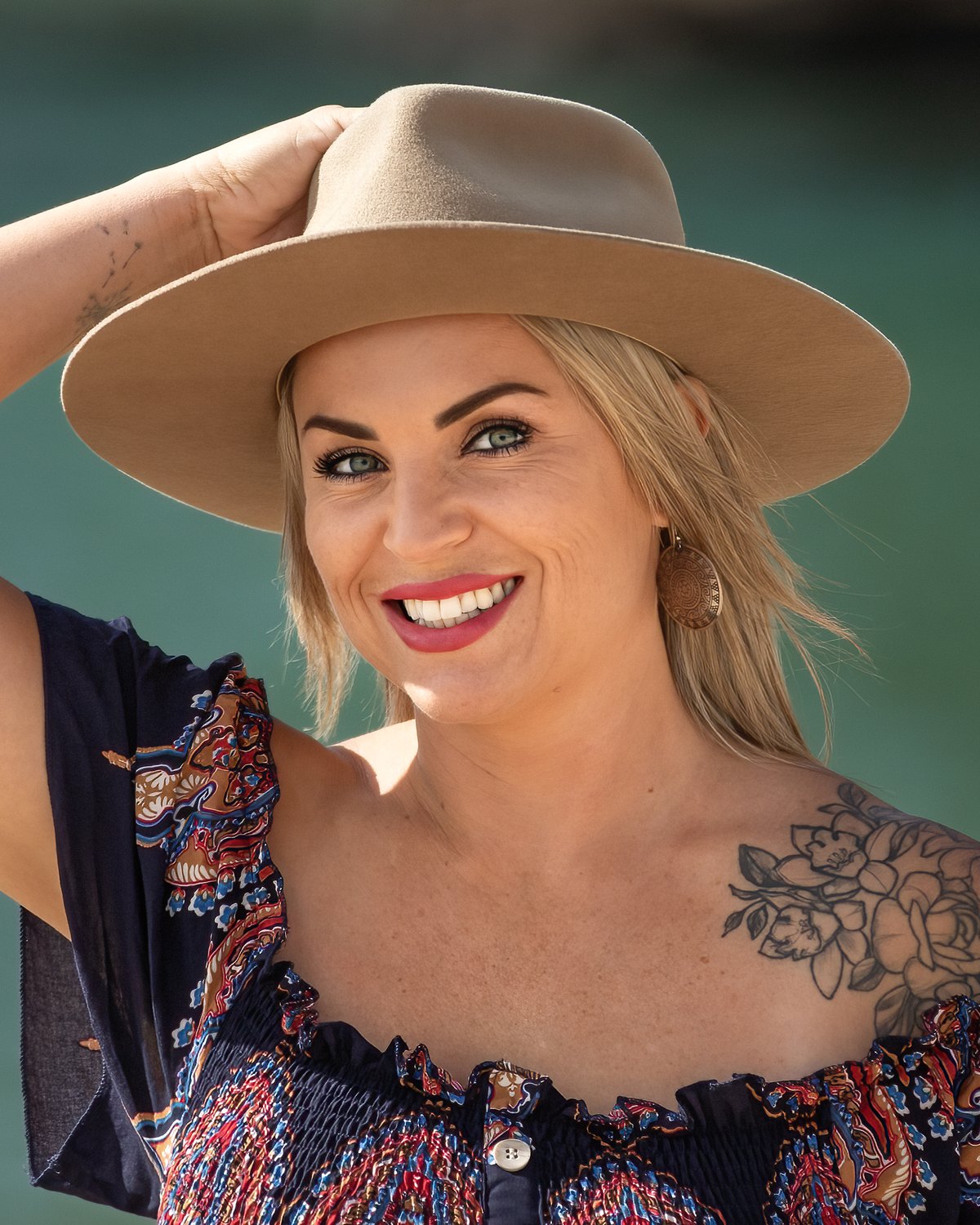Victoria Bond in her hat, smiling straight at you