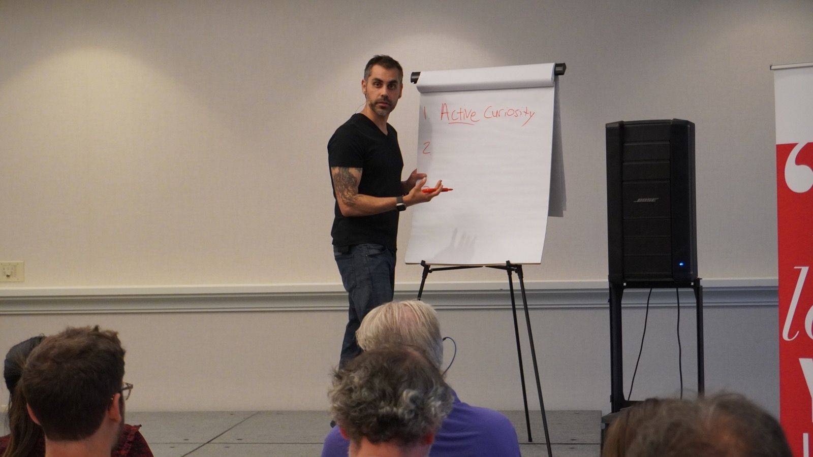 Dr. Aziz teaching confidence skills to a live audience