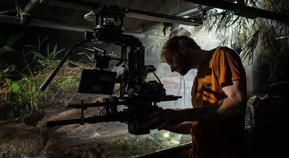 A camera on a motion rig filming a small set at night