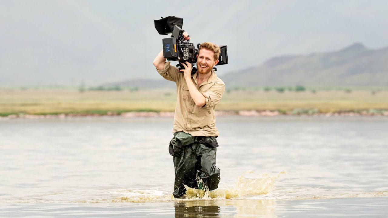 Solo documentary filmmaker shooting on location with a camera