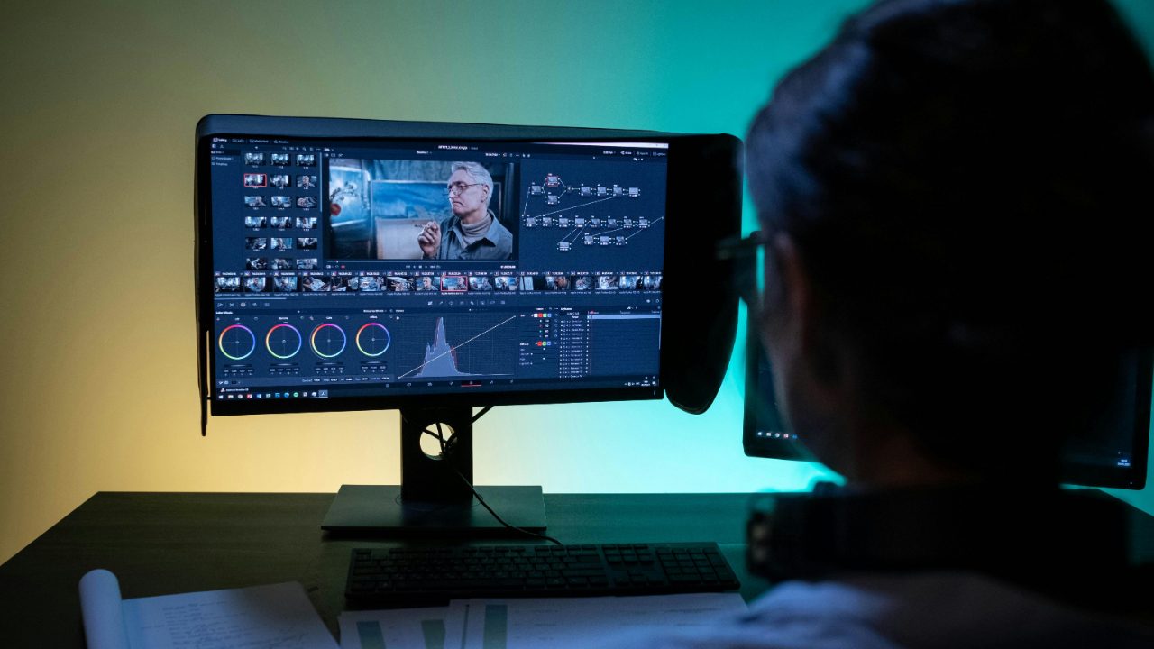 Documentary filmmaker editing a sizzle reel on a computer, how to make a documentary sizzle reel