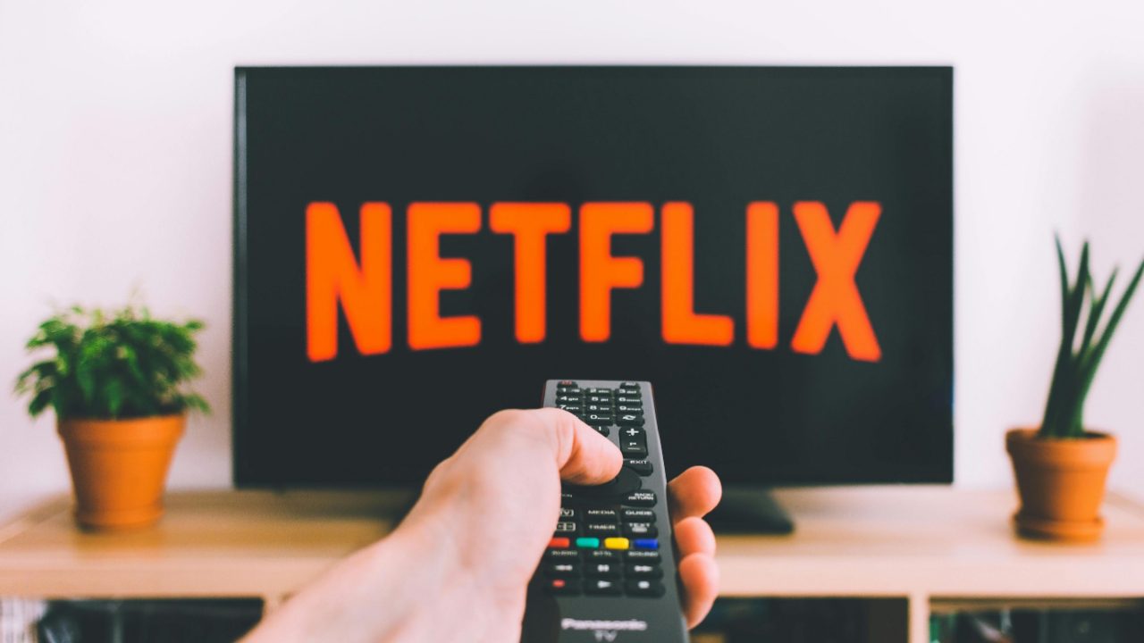 Person watching Netflix on TV - how to get your documentary on Netflix and streaming platforms
