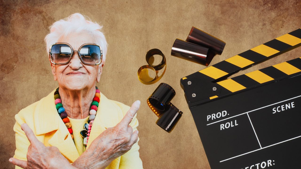 Am I too old to become a documentary filmmaker - older filmmaker holding a clapperboard
