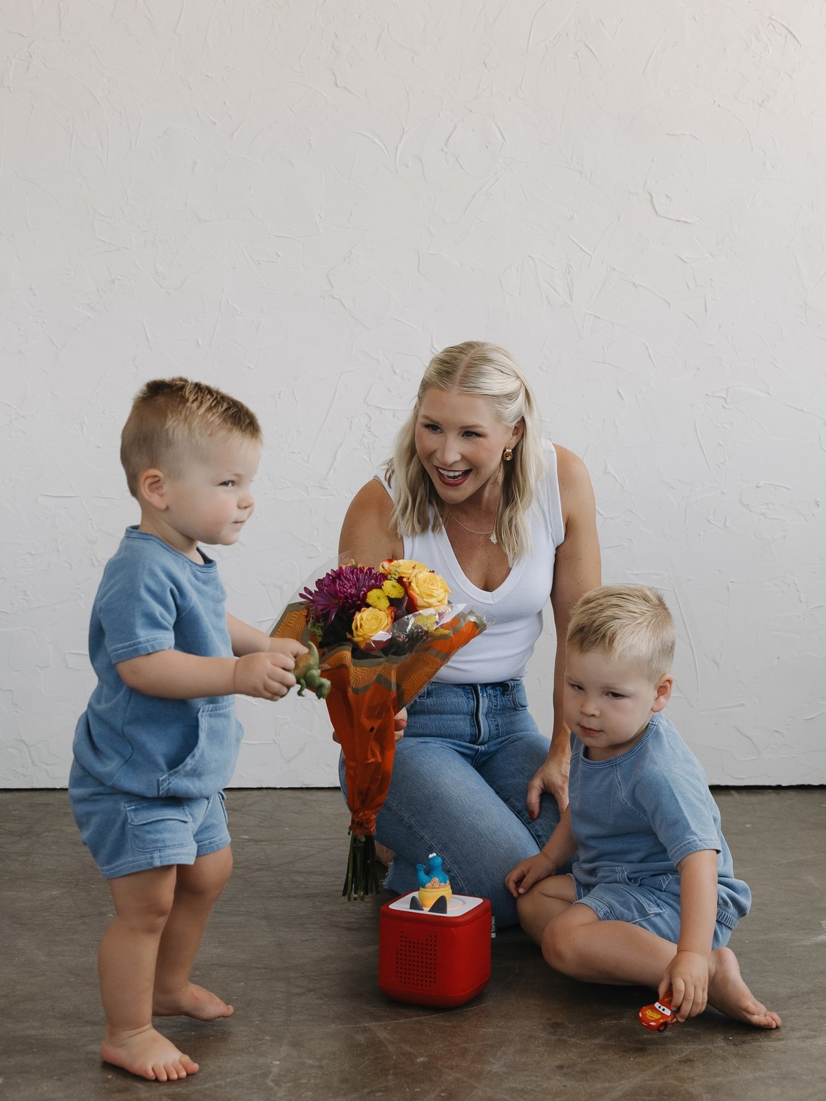 Mal laughing on the floor with her two young sons
