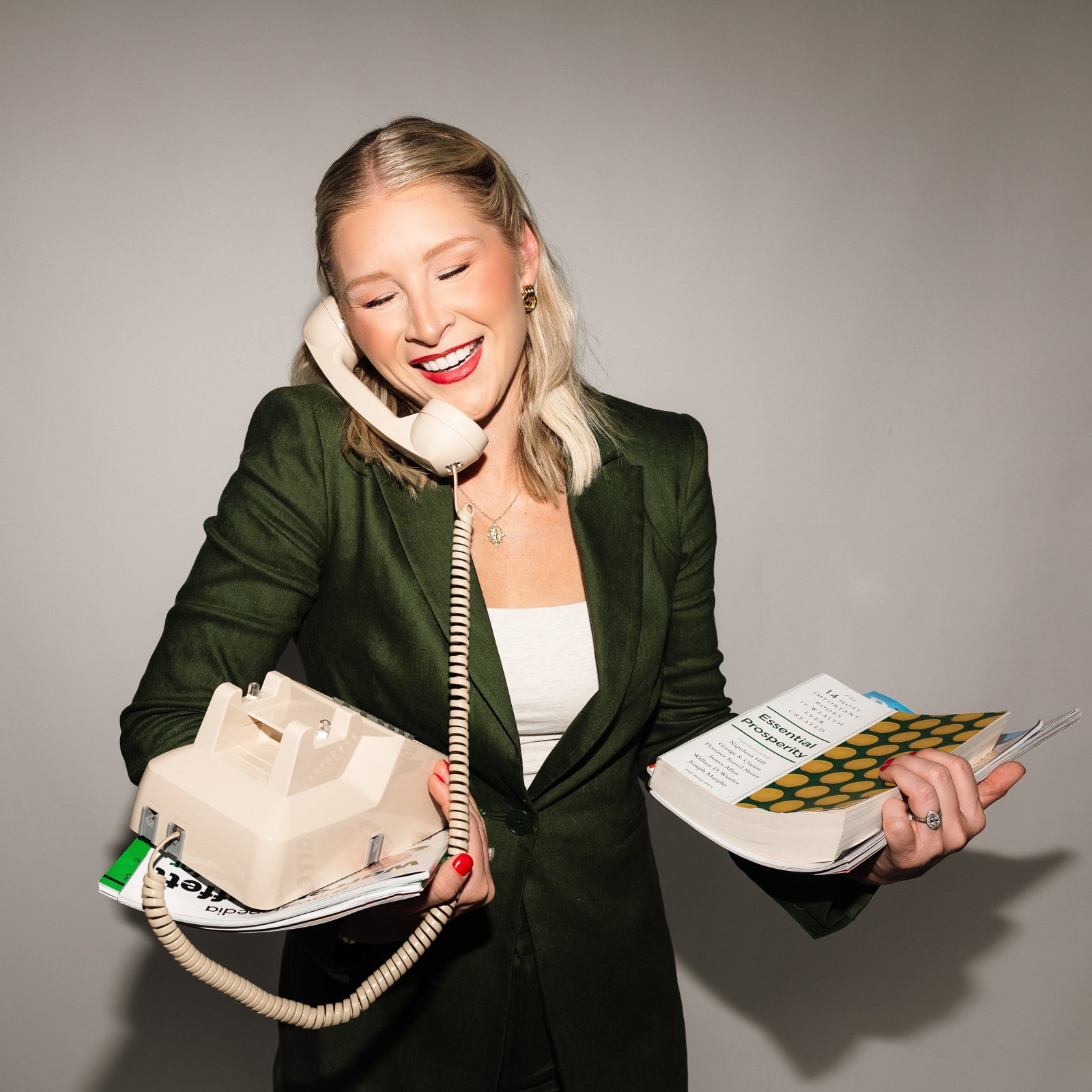 Mal on a vintage phone holding a stack of bills