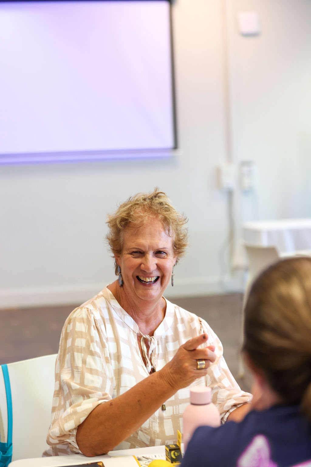 A teacher laughing during a session