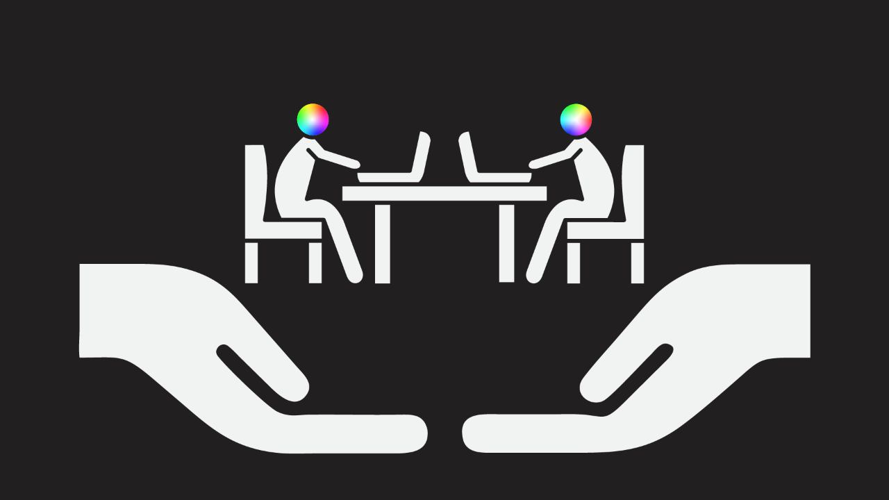 An icon of two people sat at desks opposite each other working on their laptops. Their heads are coloured in the full spectrum of colour. There are two large hands beneath them to show they are being supported