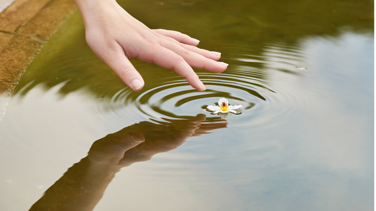 woman touching water ripples