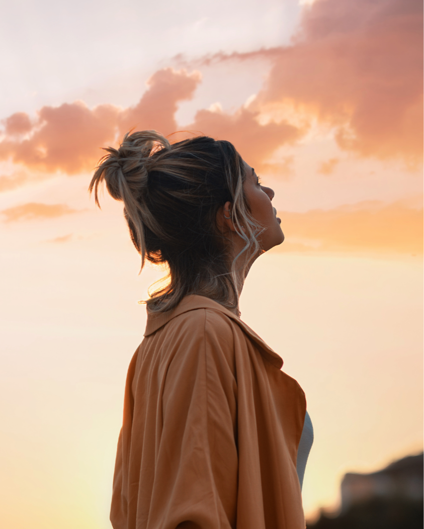 Trust your intuition, a woman looking at the sunset