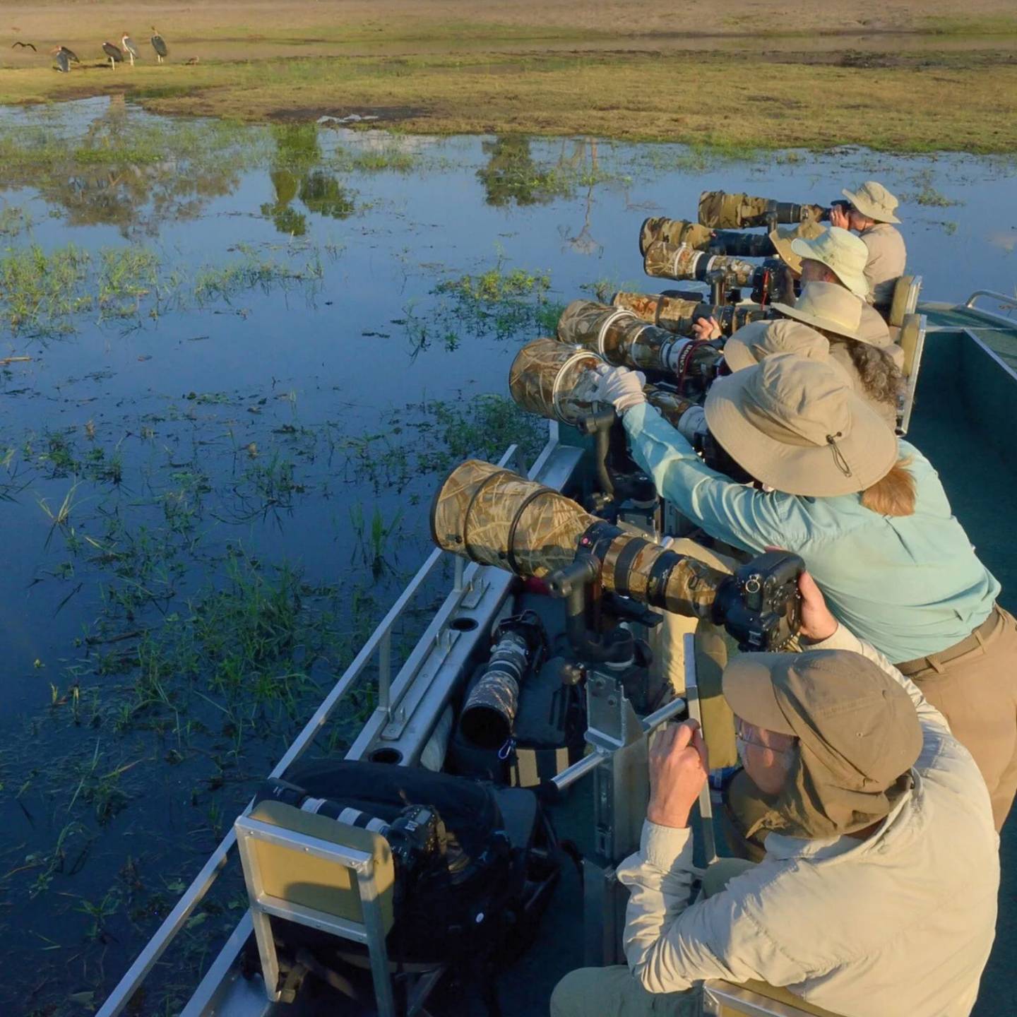 Photographers working from a specialized photography boat