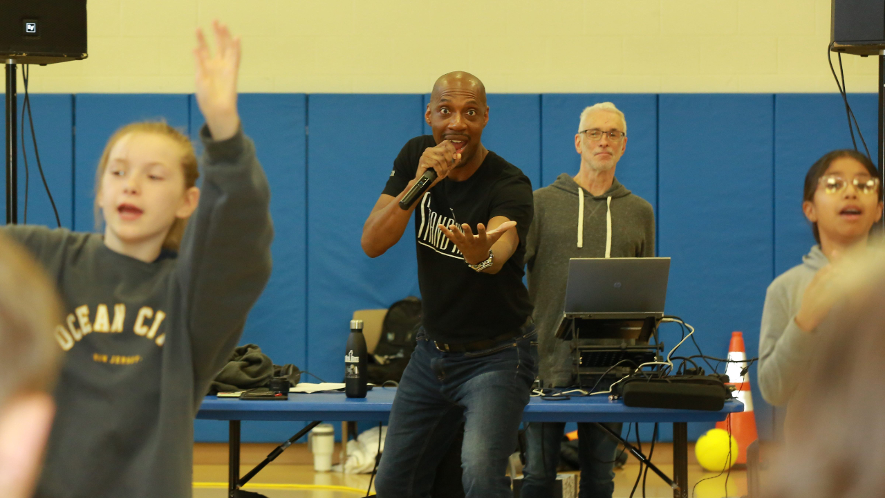 Stand Tall Steve Bollar emcees a motivational rally before the end of school.