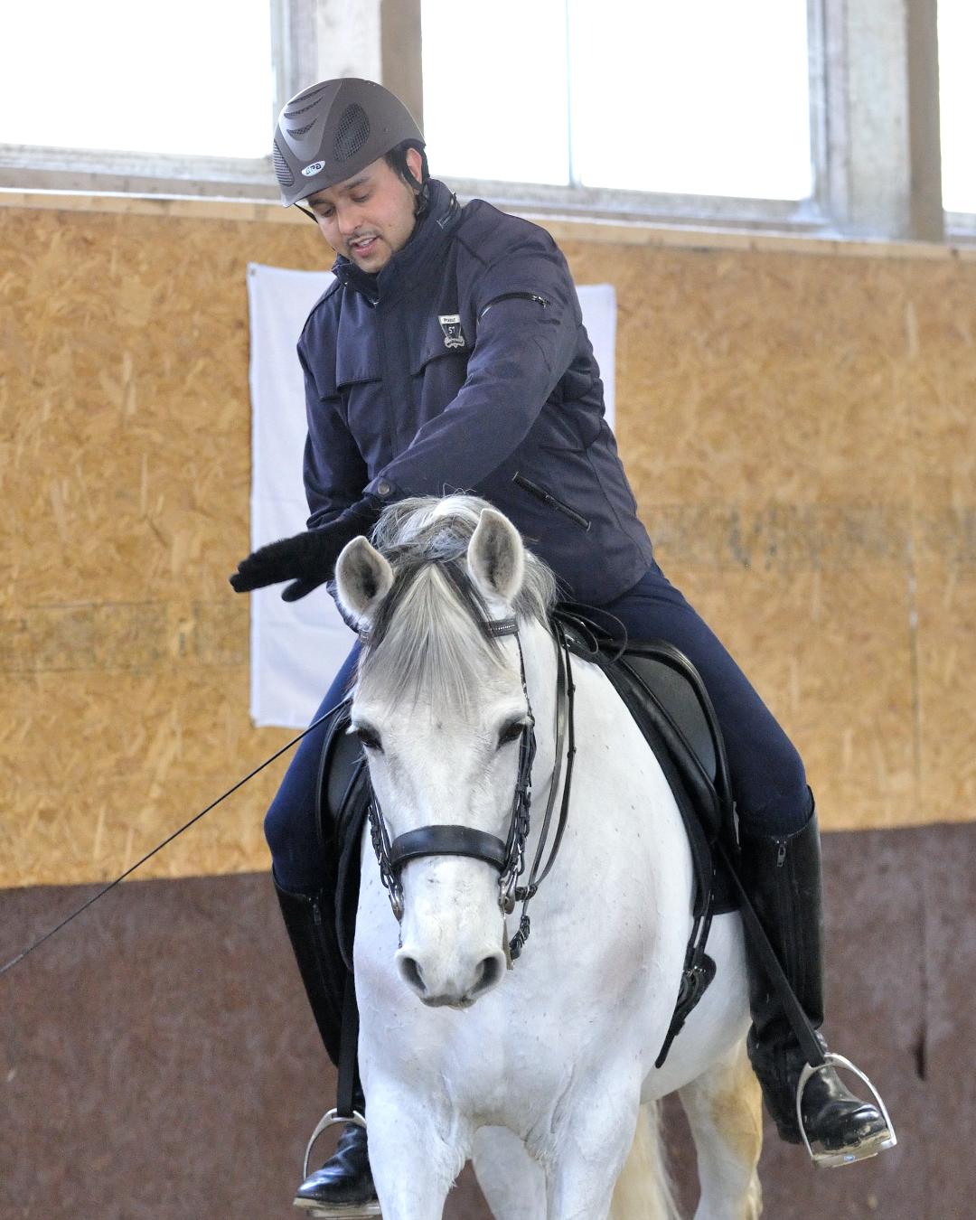 Dave Thind sharing a quiet moment of connection with a grey horse