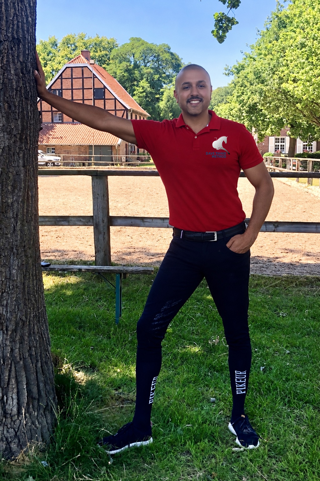 Dave Thind smiling beside the riding arena on a sunny day