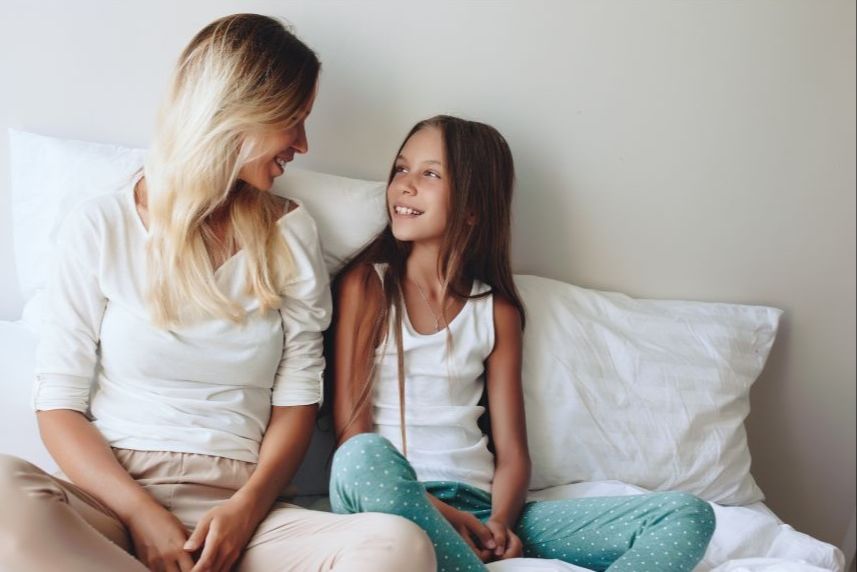Claude responded: Mom and older daughter sharing a warm moment togetherMom and older daughter sharing a warm moment together