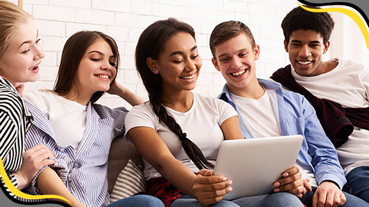 a small group of teens taking a photo on a tablet