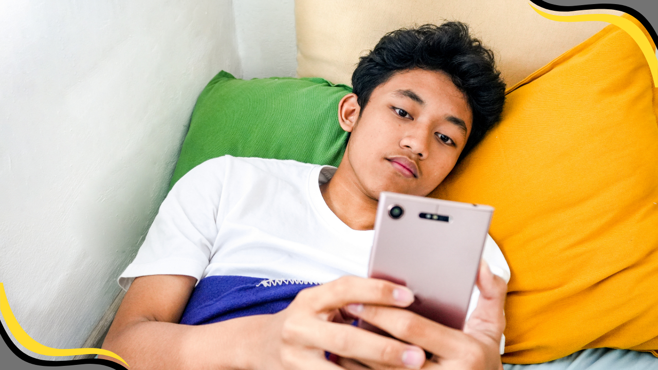 teenager in bed on their phone