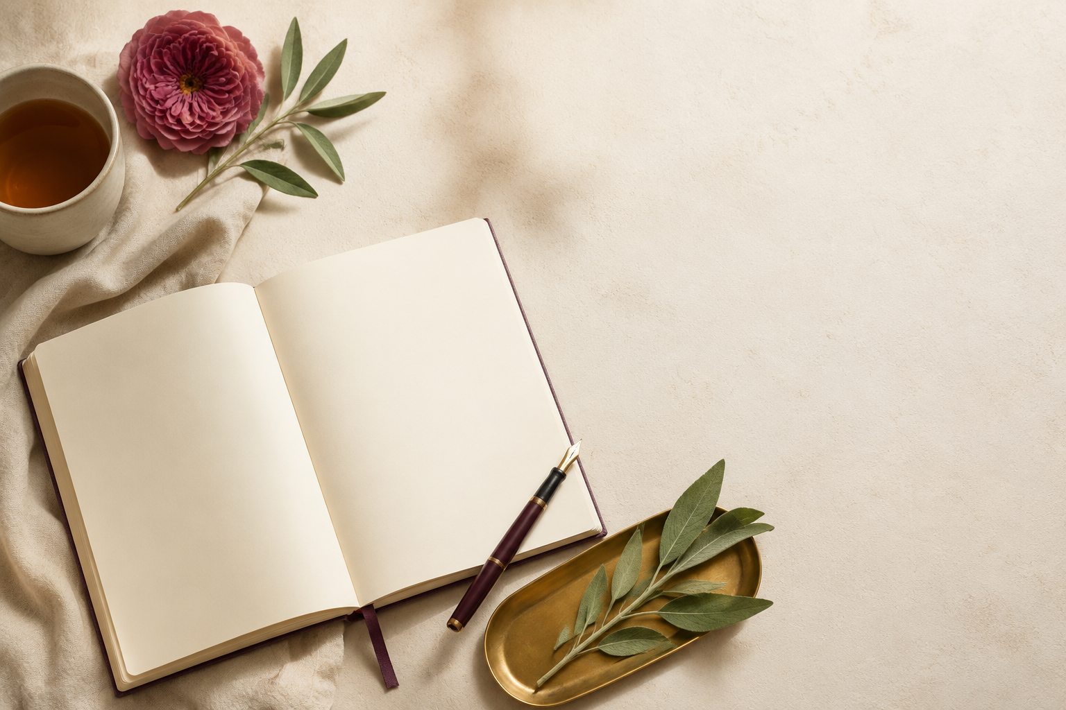 A journal and cup of tea arranged for a calming Soft Life Reset ritual
