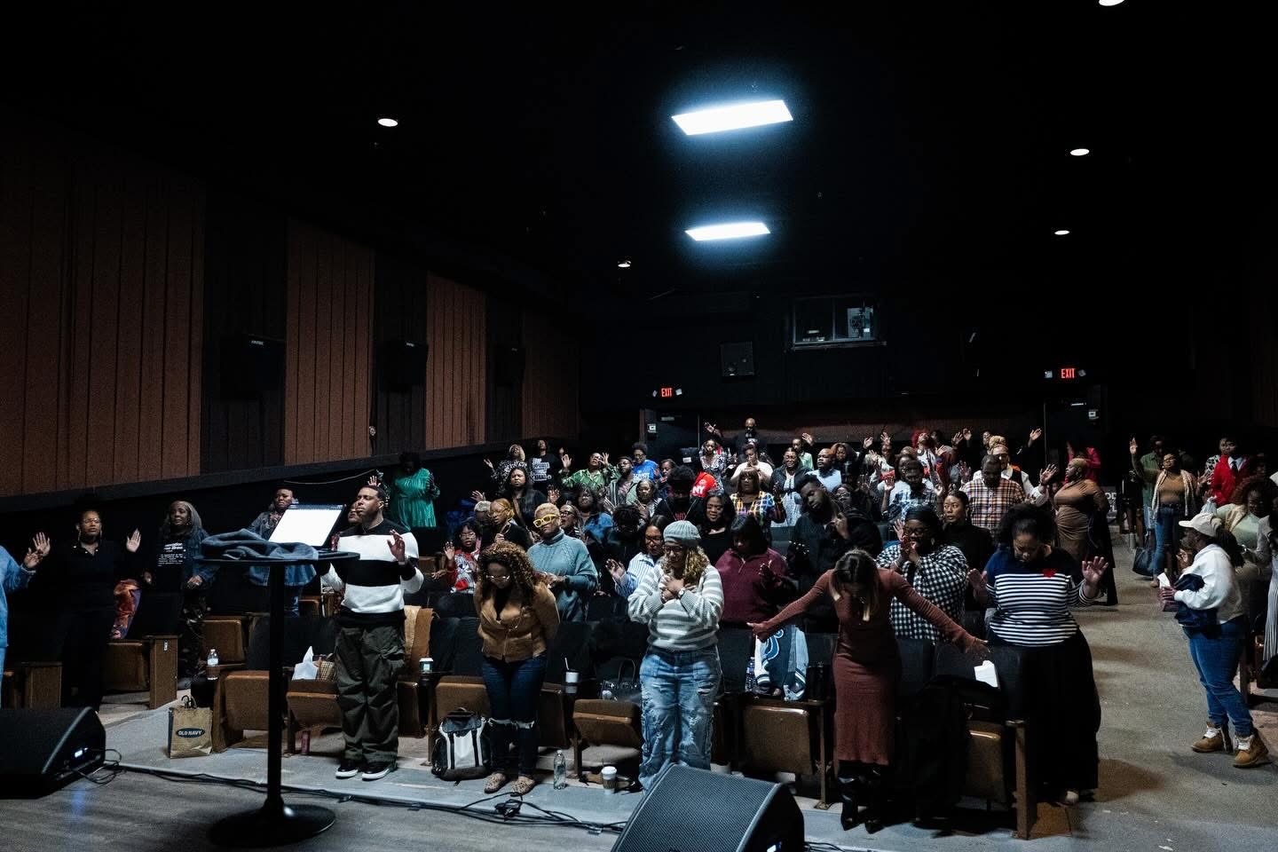 The Cultivate ATL congregation standing in worship