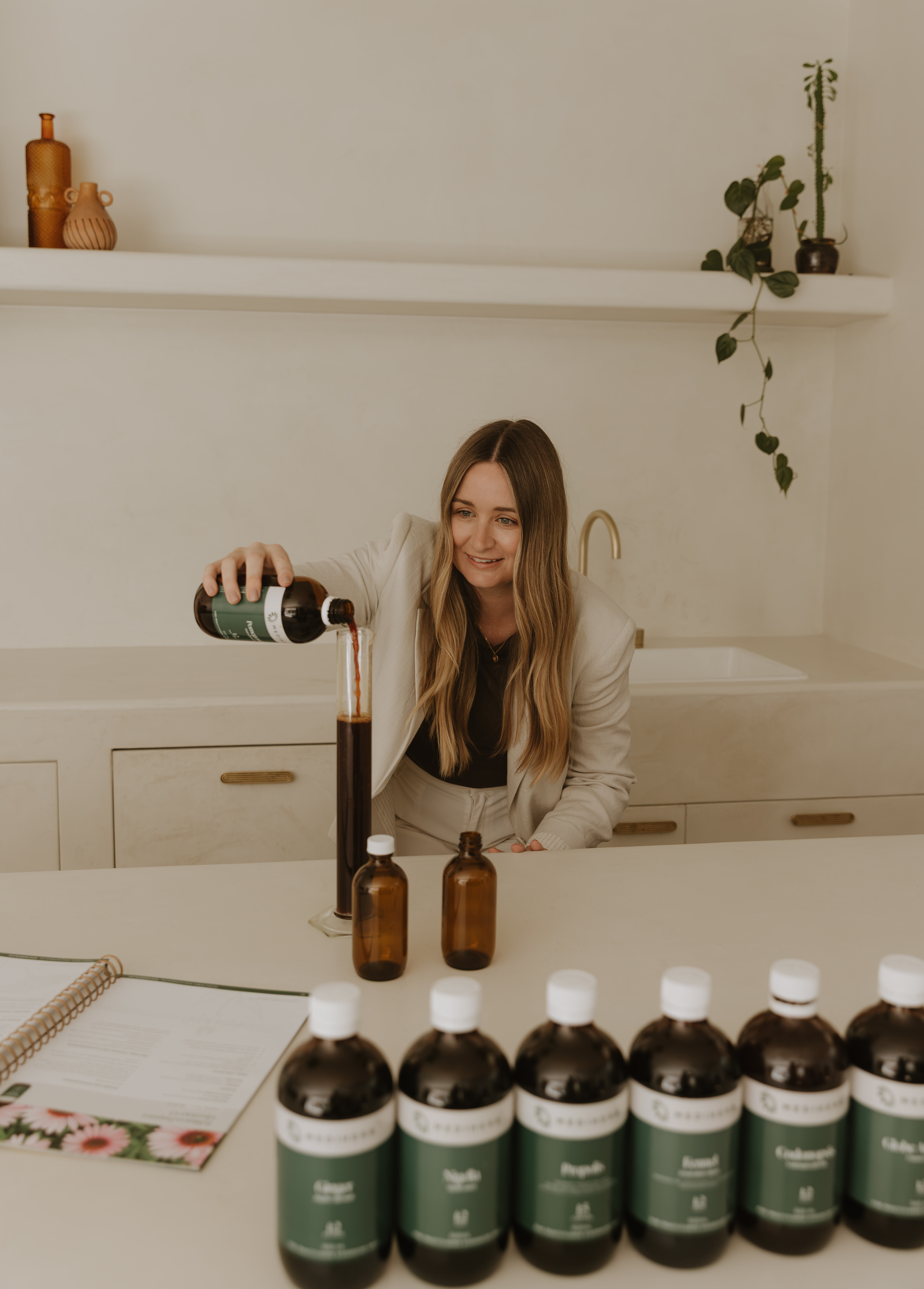 Karly Raven preparing a herbal medicine formula in the Nourished Gut Clinic dispensary