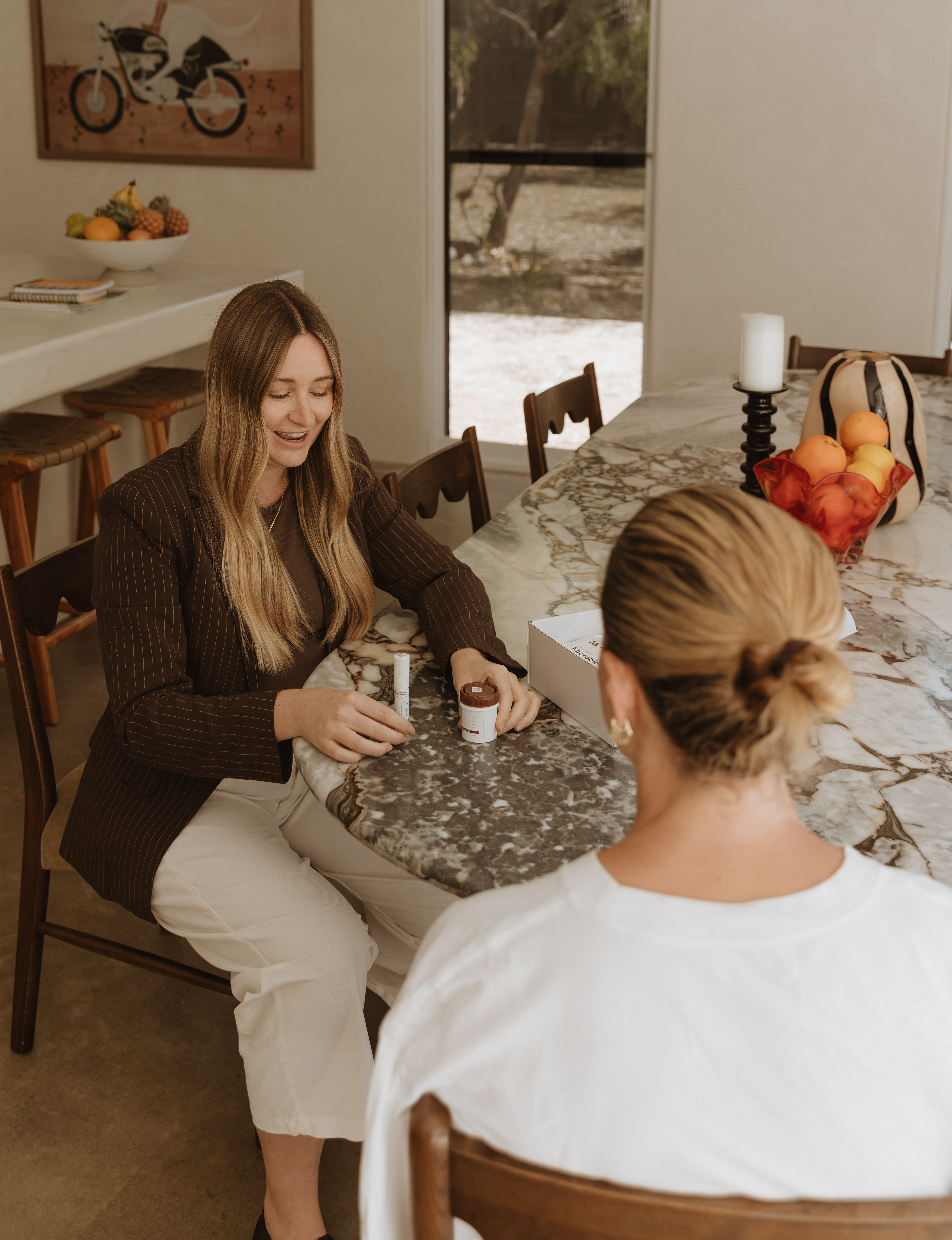 Karly Raven in consultation reviewing a microbiome test kit with a Nourished Gut Clinic client