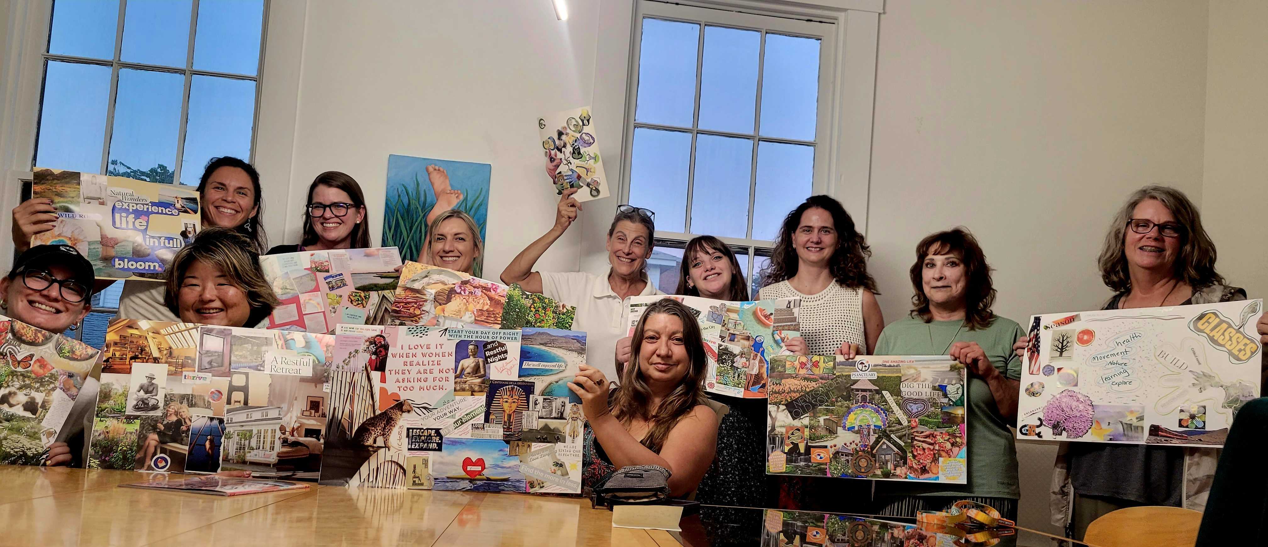 Women holding up the vision boards they made together