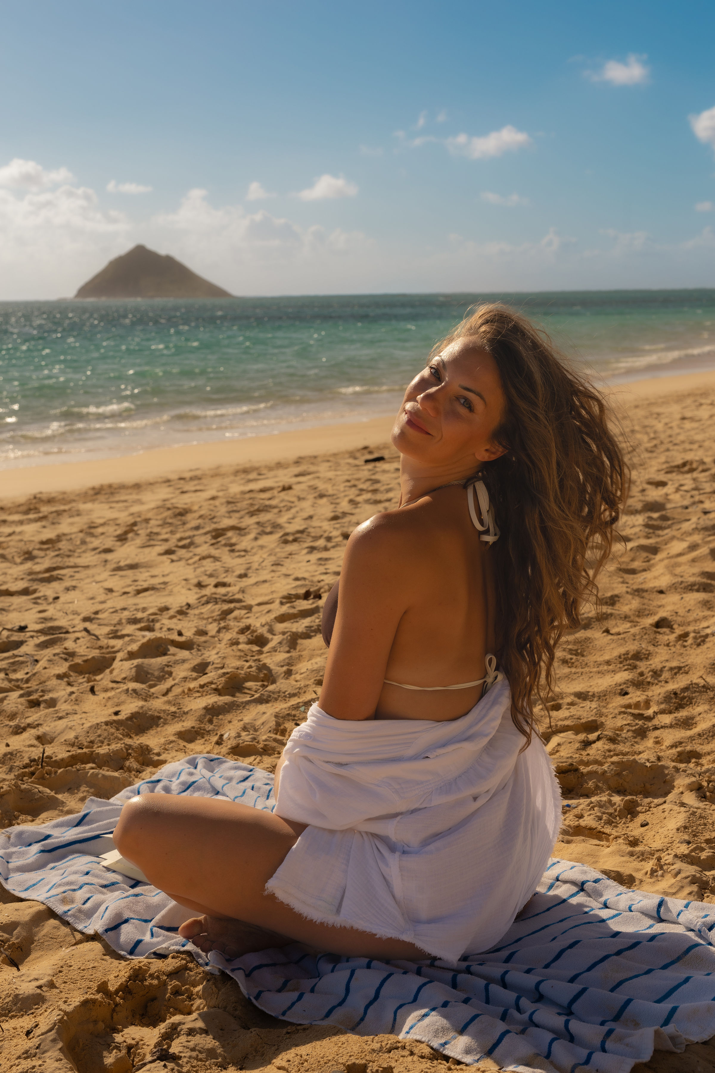 Lindsey smiling over her shoulder on the beach