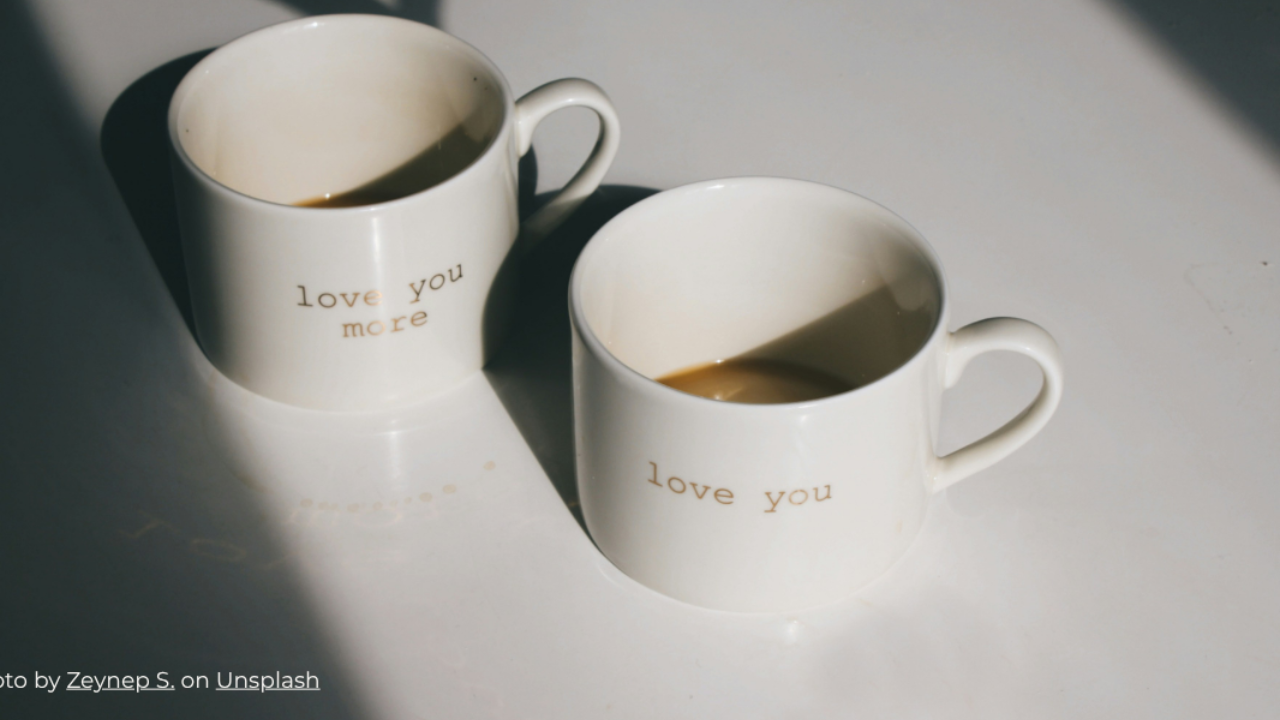 Coffee cups with "love you" and "love you more" representing continuing connection with loved ones in spirit