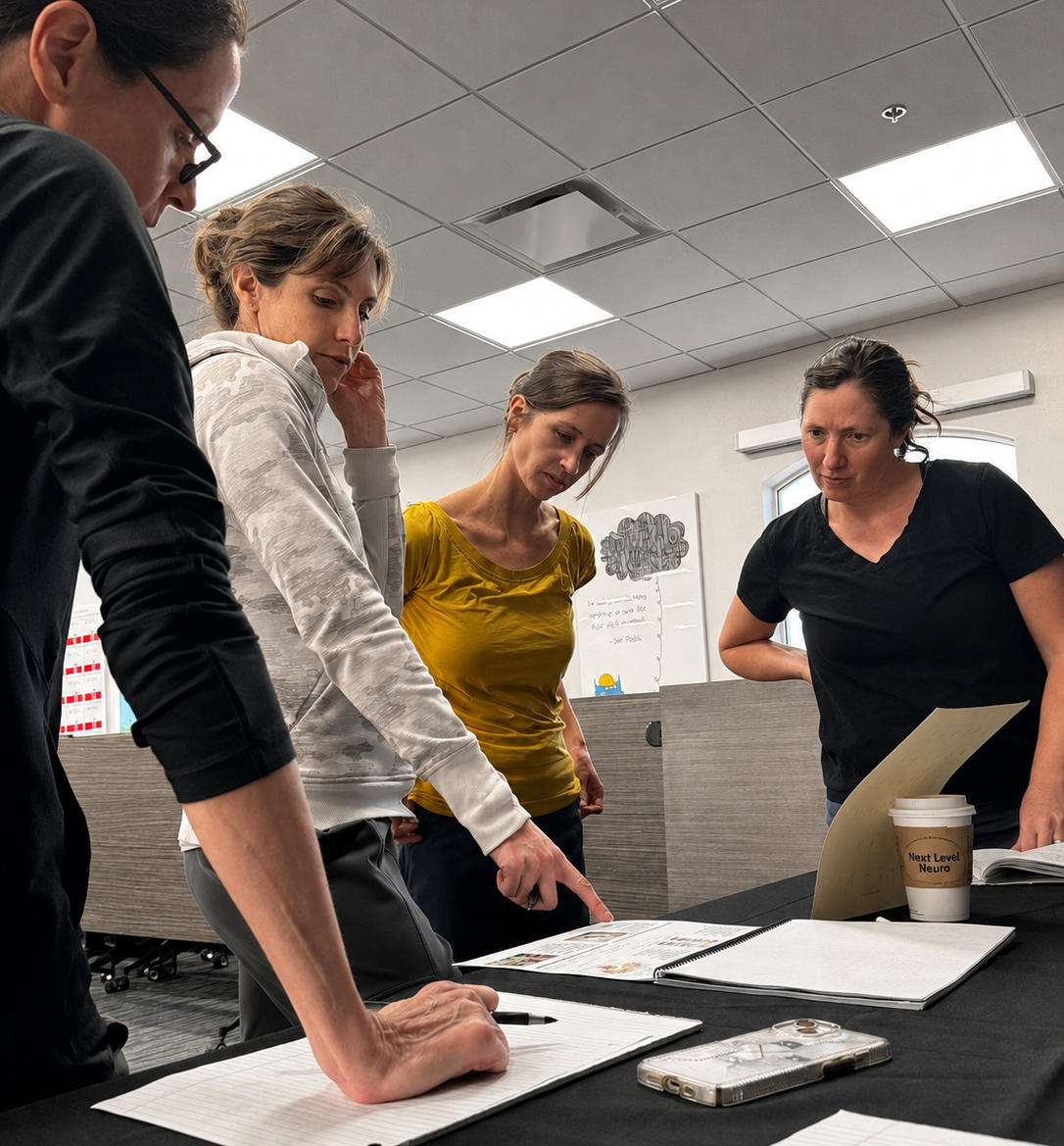 Four female Next Level Neuro practitioners work on assessment for applied neurology