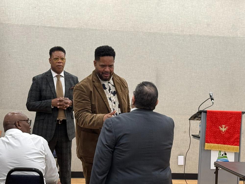 Men connecting in conversation at a church gathering.