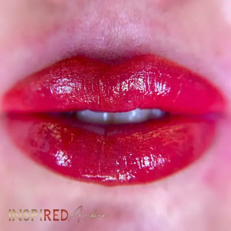 Close up of swollen, freshly done red permanent makeup lips