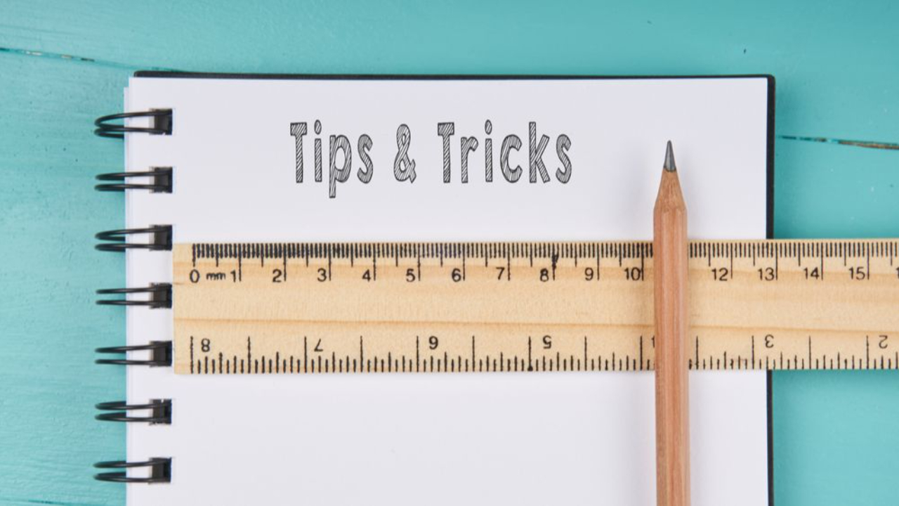 Notepad with Tips and Tricks written on it for ten tips to manage presentation anxiety