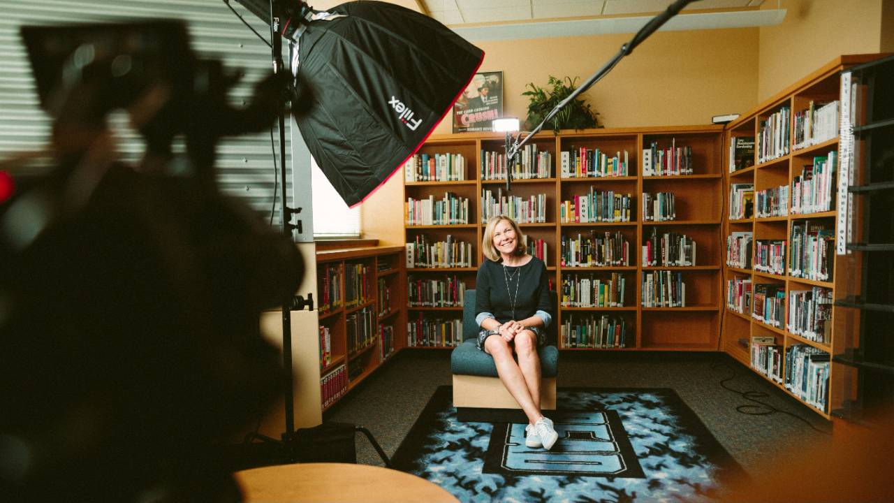 Confident lady being interviewed in a library