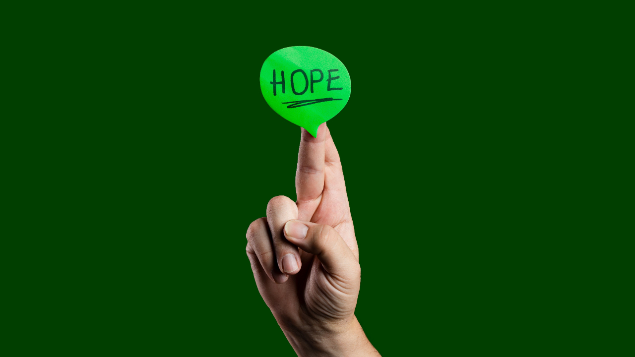 closeup of fingers crossed with the word HOPE across the top