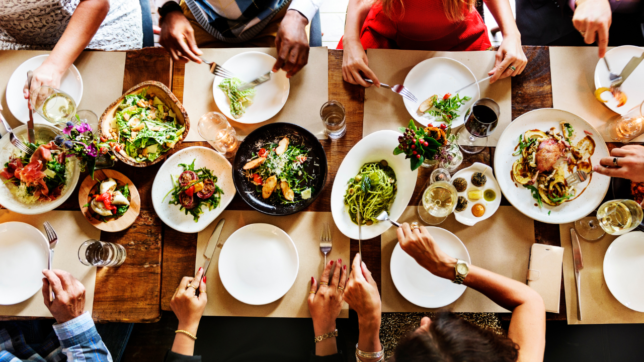 Friends sharing a Mediterranean-style meal around a table