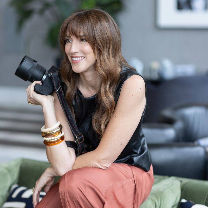 Vanessa Joy smiling and holding her camera