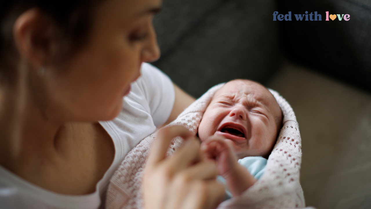 Mother holding and comforting a crying newborn during the baby witching hour
