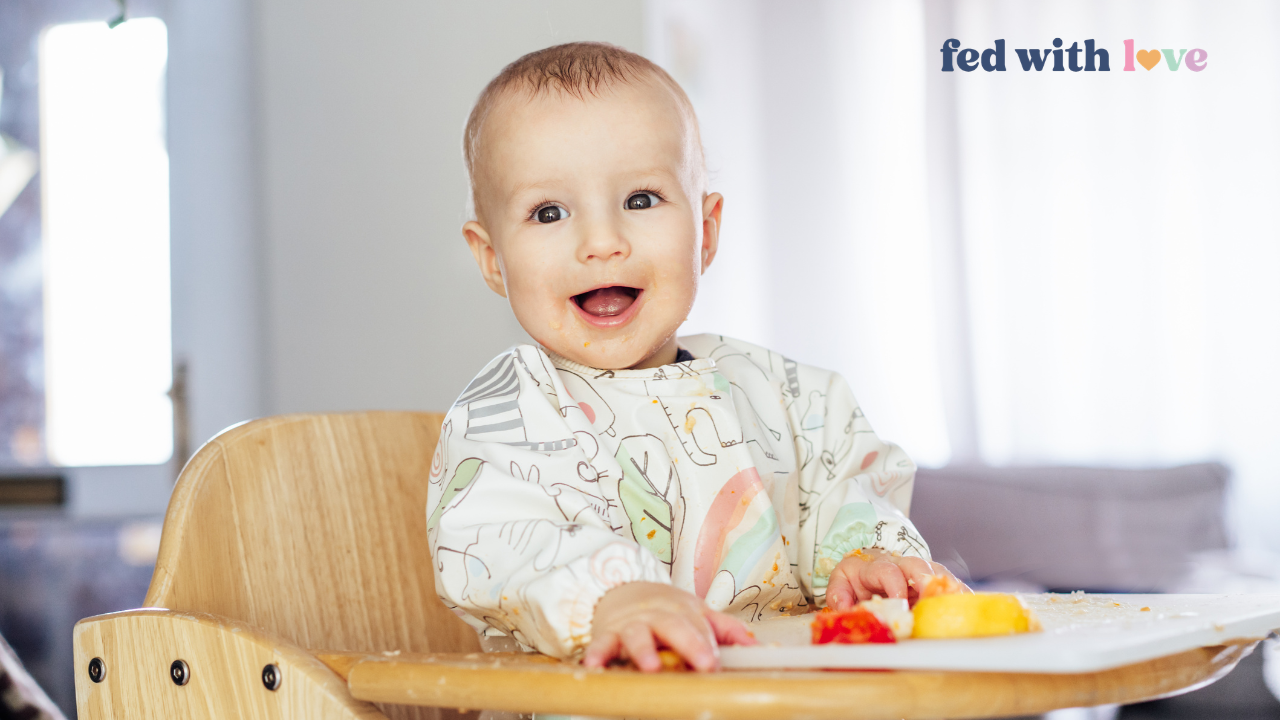 Baby sitting in high chair eating finger foods during starting solids, demonstrating baby-led weaning vs purees feeding approach