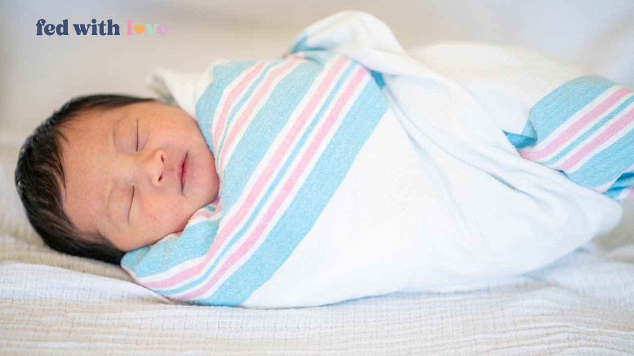 Sleepy newborn swaddled in a hospital blanket sleeping peacefully during the first days of life, illustrating normal newborn sleepiness and common feeding challenges with sleepy babies.