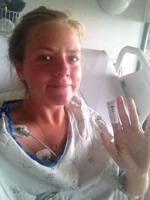 Katie Lain in a hospital room during a medical recovery.