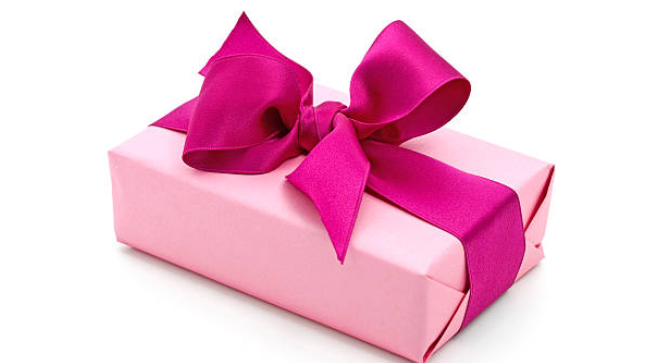 photo of wrapped present with teal blue ribbon on light teal background